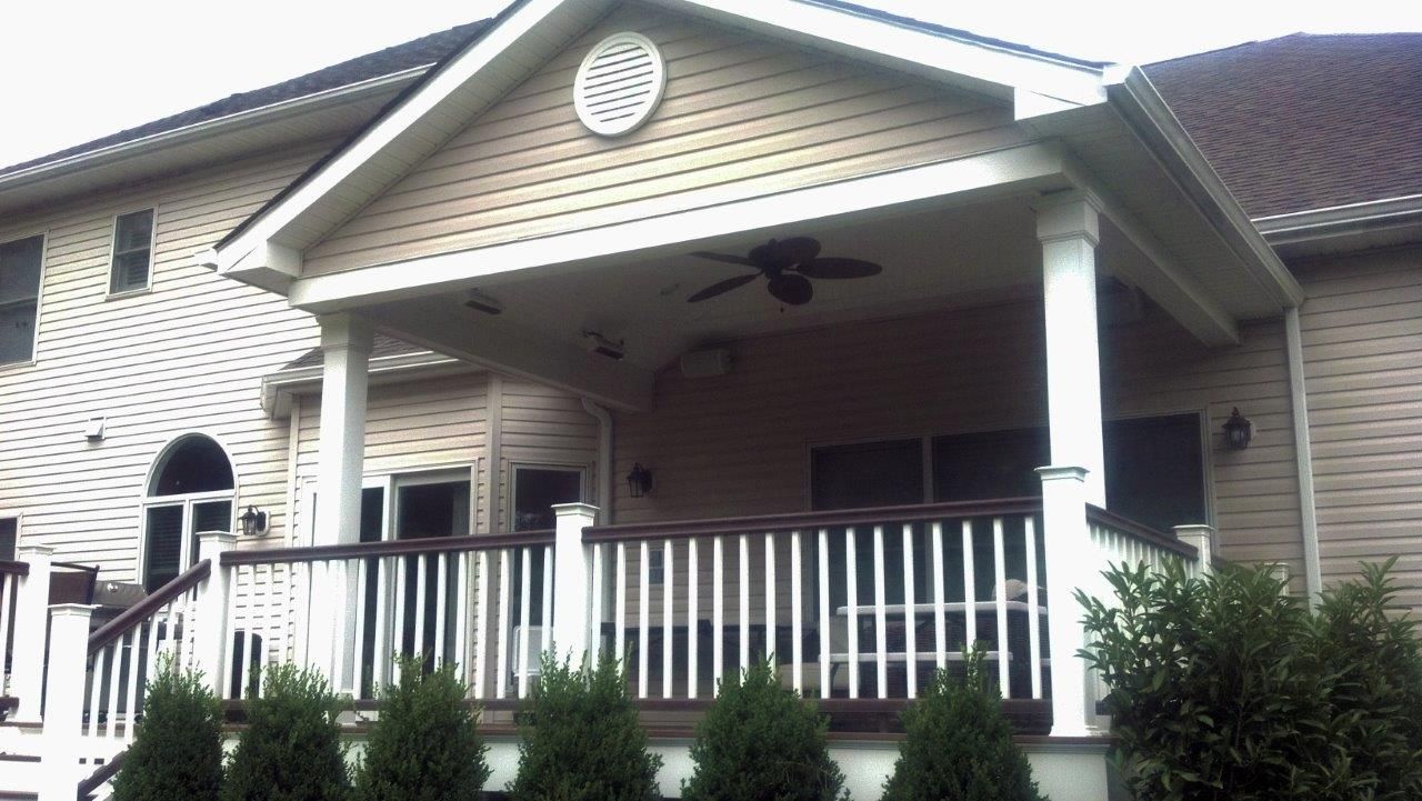 A house with a porch and a ceiling fan