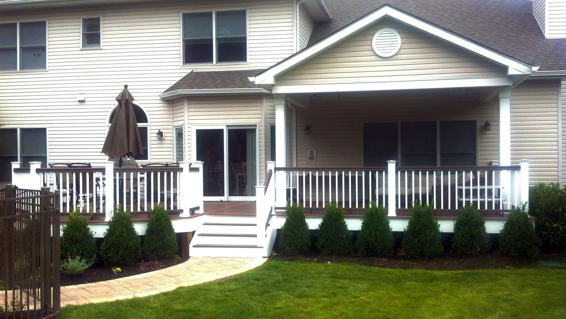 A house with a porch and a walkway leading to it
