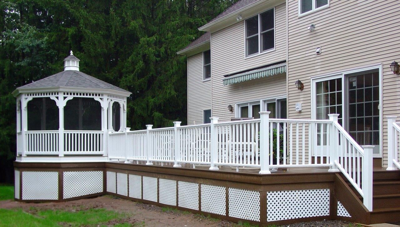 A house with a screened in gazebo on the deck