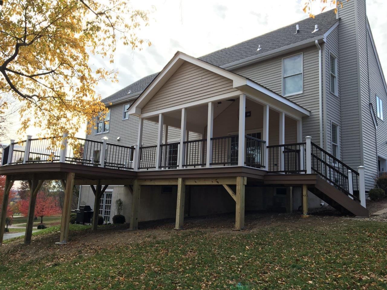 A large house with a large deck in front of it