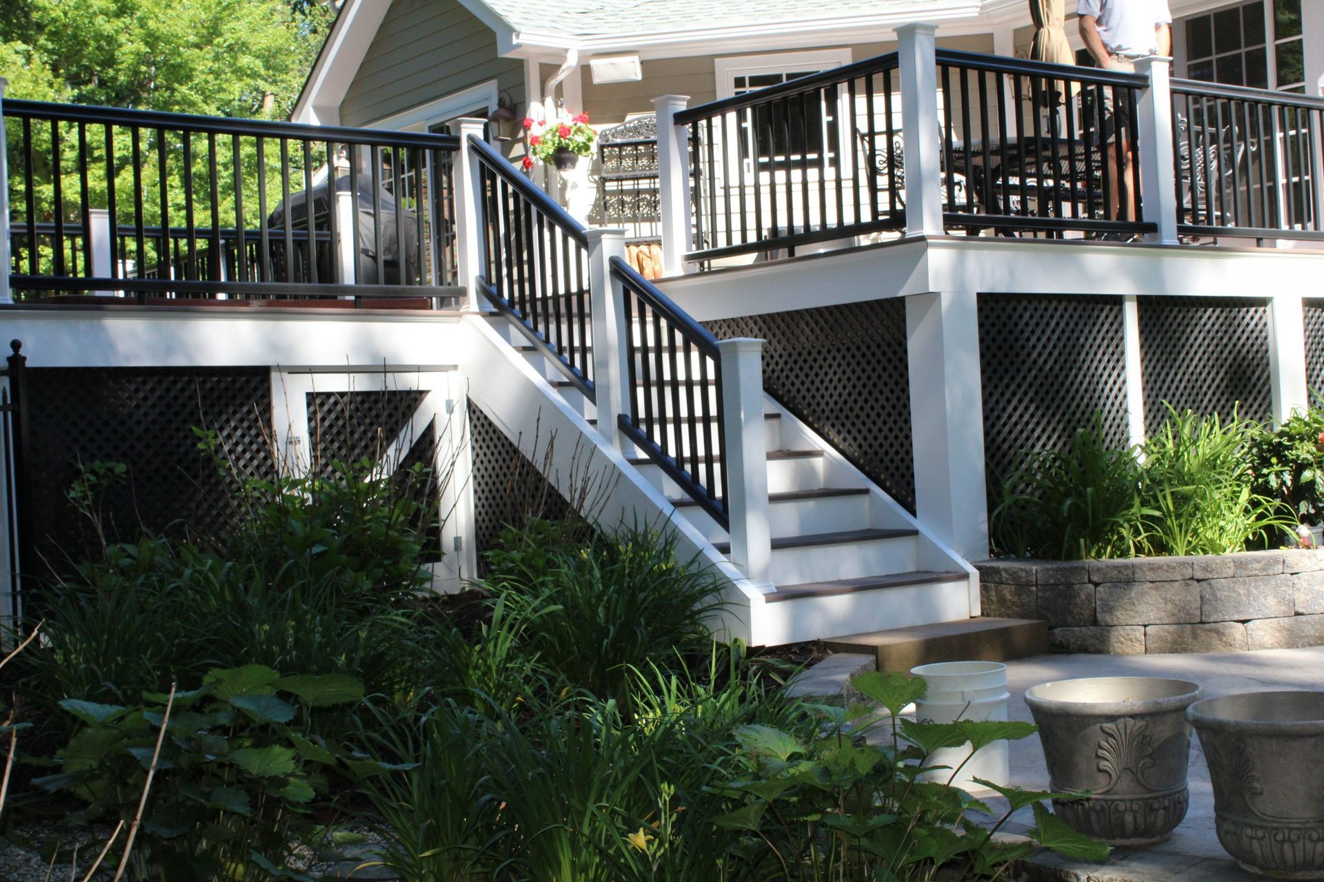 Multi-level deck with black railing and landscaping built by New Dimensions Deck Contractors NJ