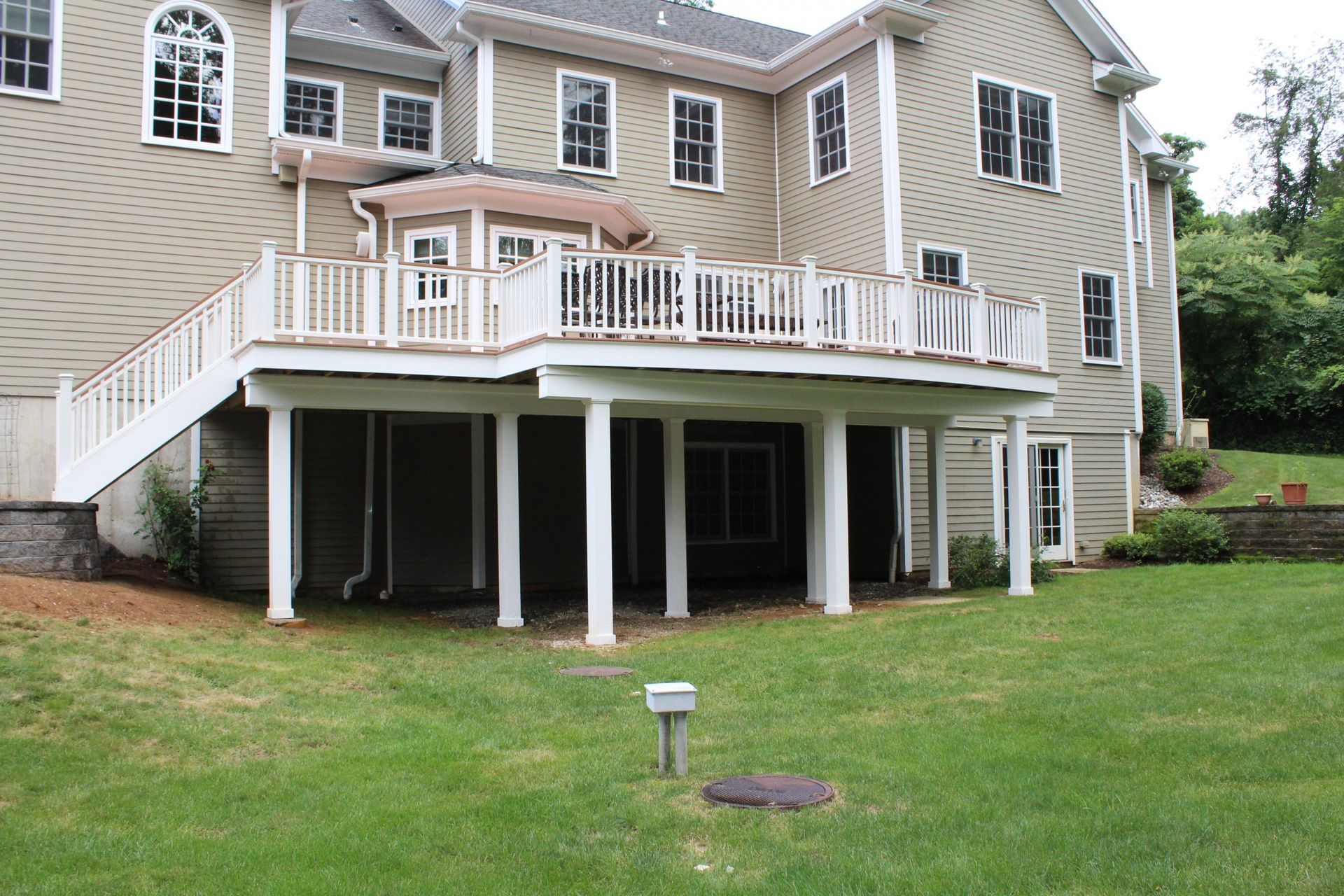 Elevated deck with white columns and under-deck space.