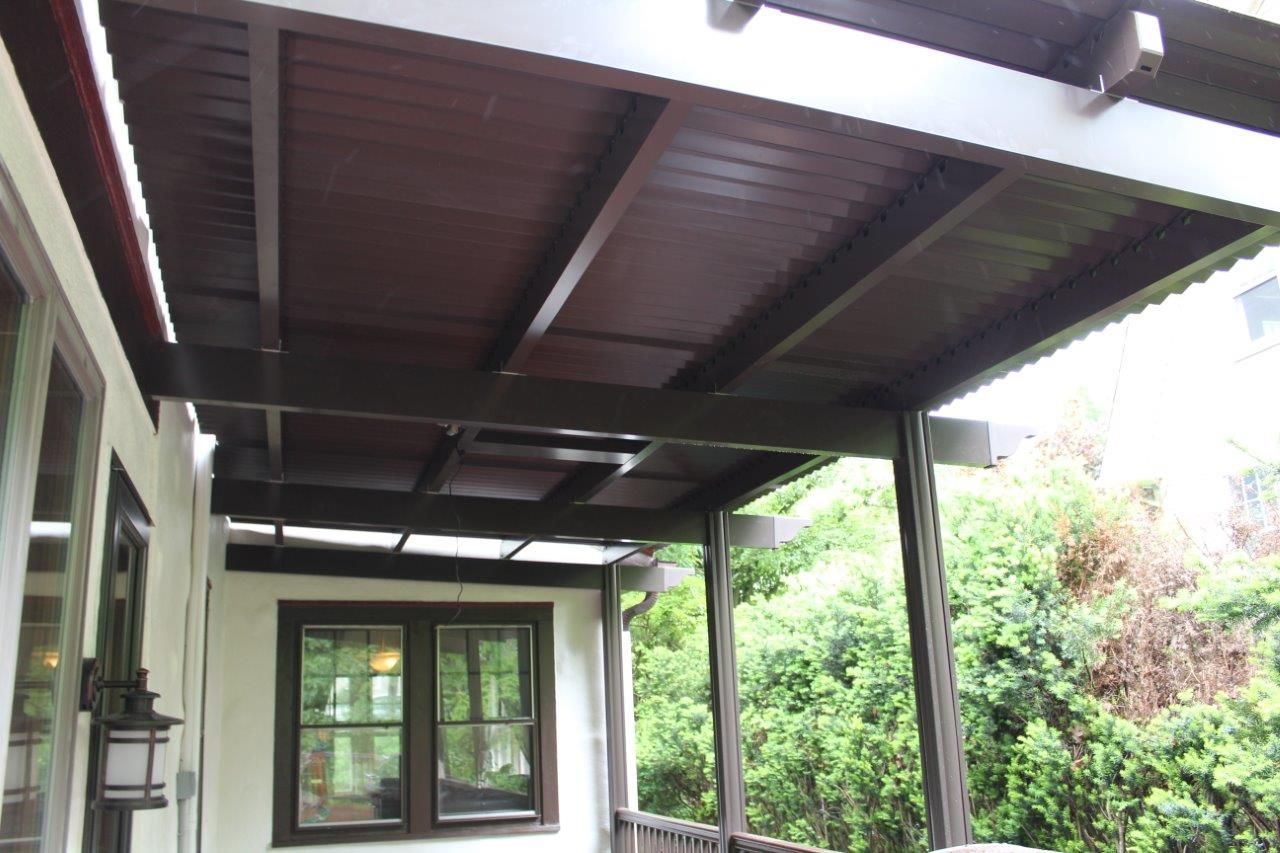 A porch with a wooden roof and a window