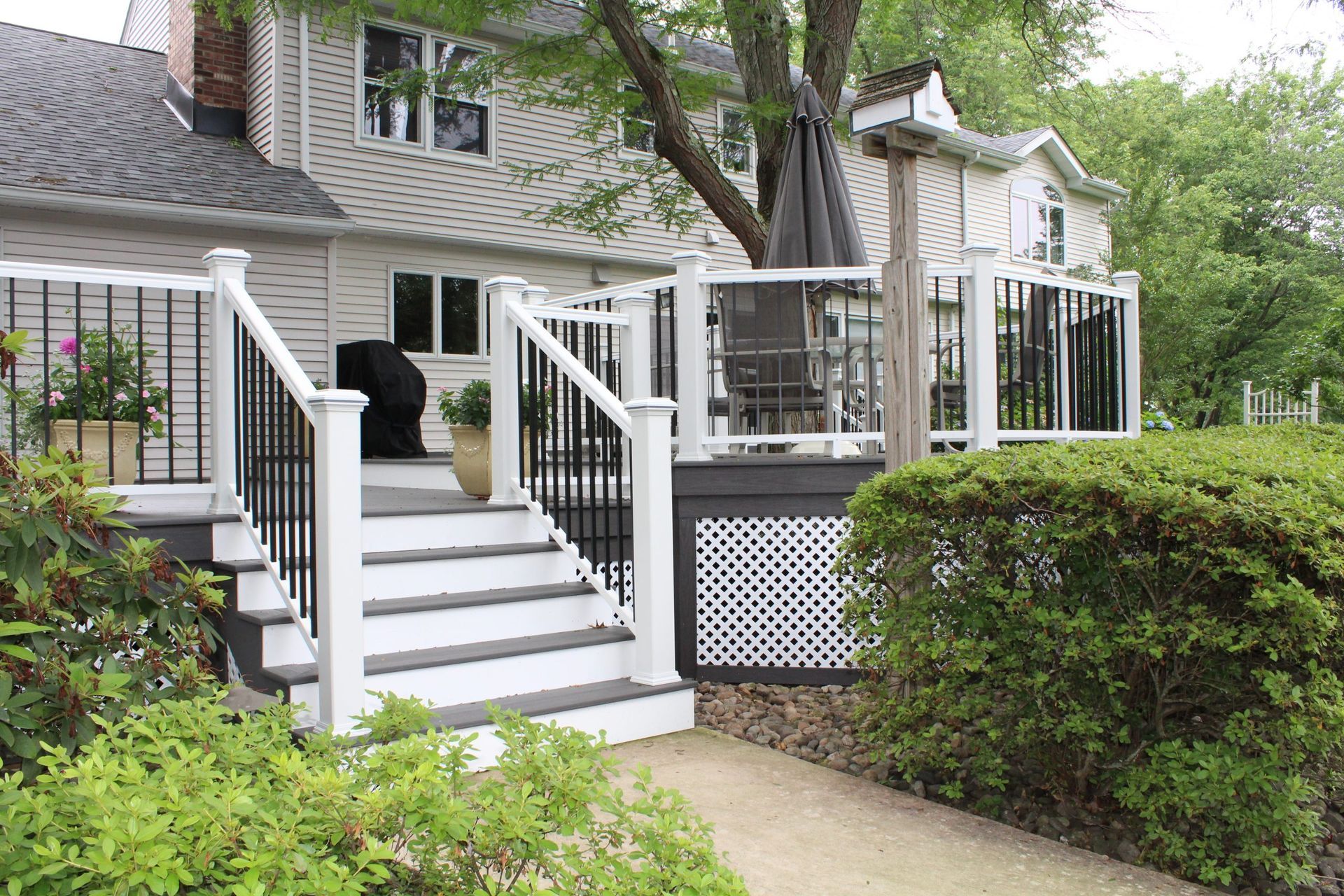 Poolside deck with cable railings and modern furniture.