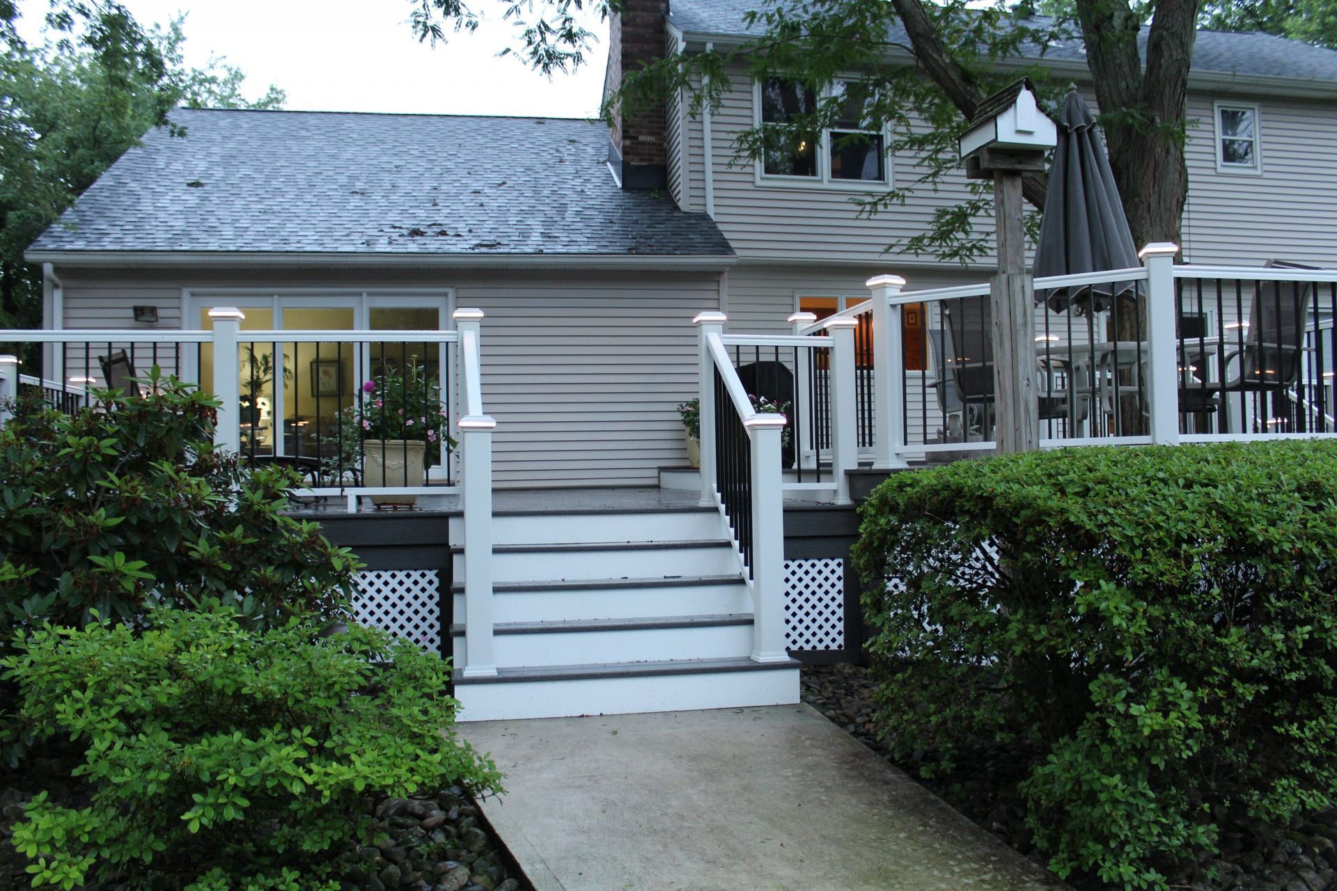 Raised deck with white and black railing combination.