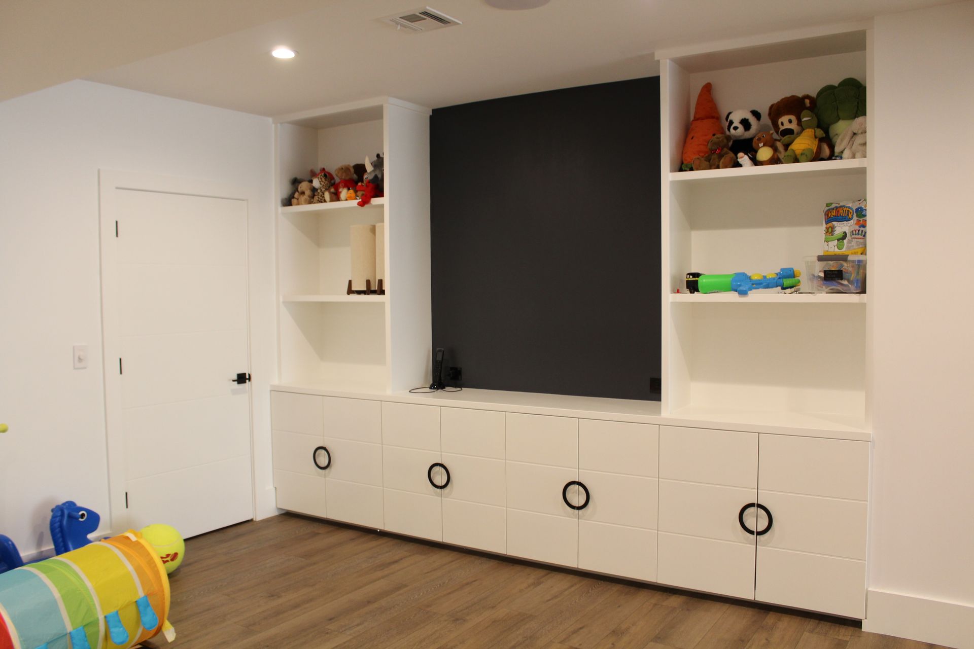 A room with a lot of shelves and toys on them