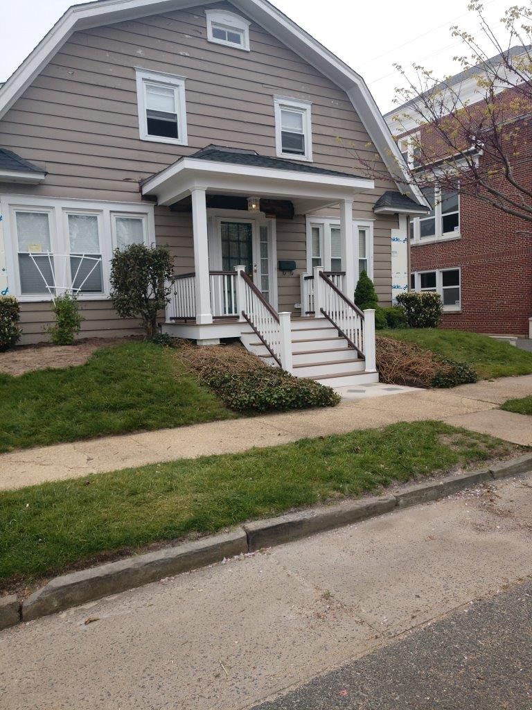 A house with a porch and stairs leading up to it