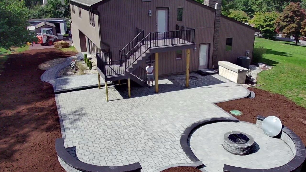 An aerial view of a house with a patio and a fire pit.