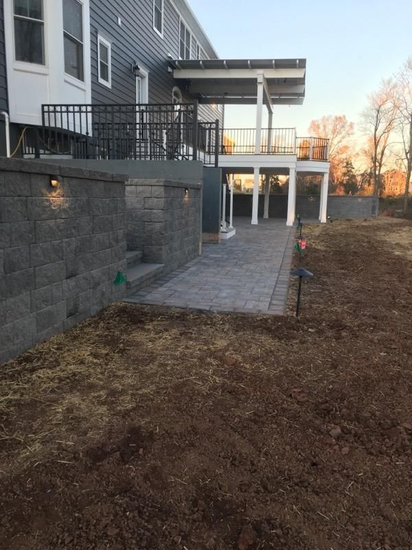 The backyard of a house with a patio and a deck.