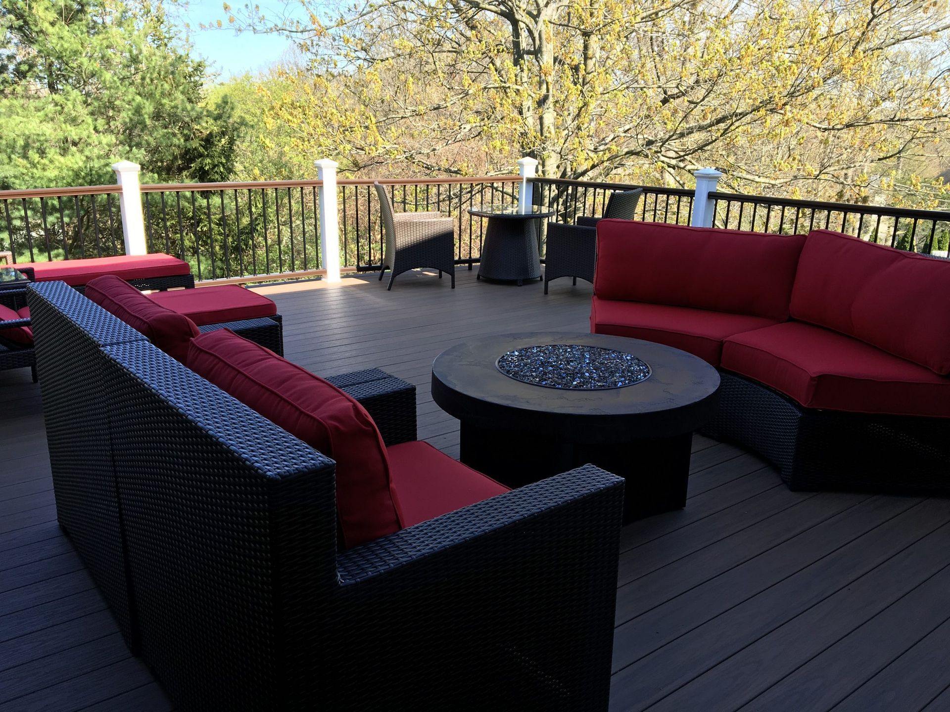 Outdoor deck with modern seating area and fire table built by NJ deck experts New Dimensions