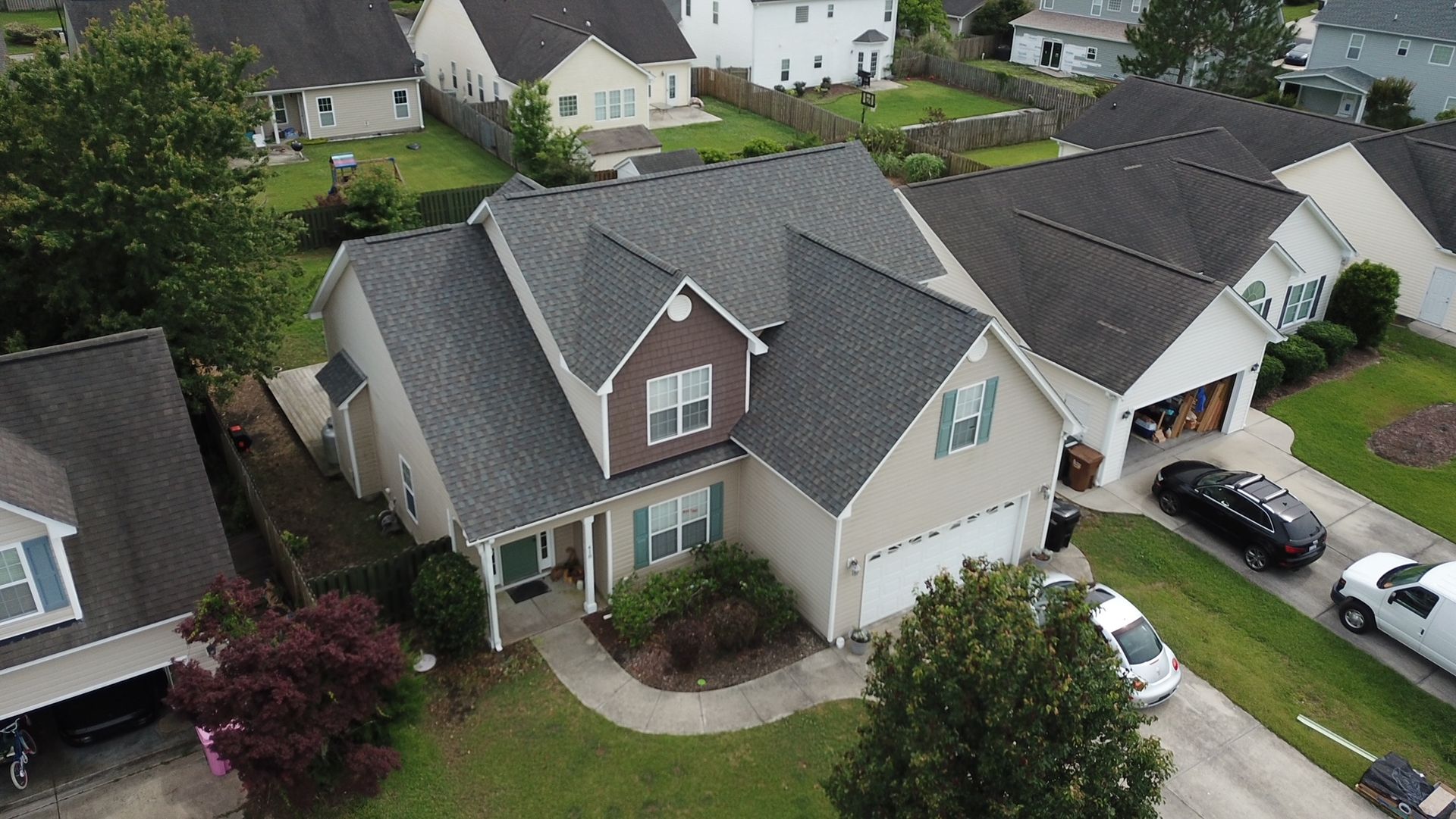 An aerial view of a house in a residential neighborhood