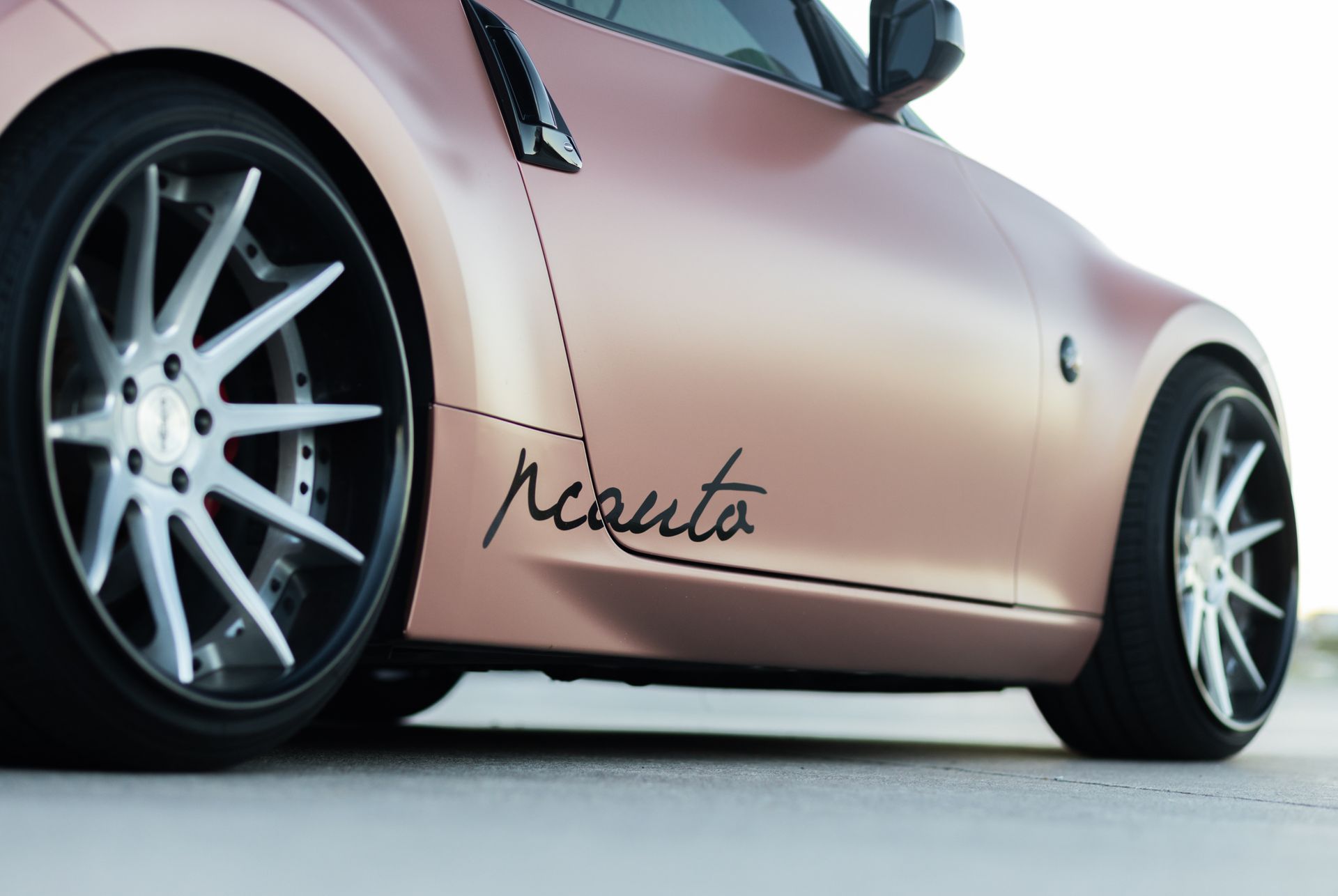 Rose gold sports car with silver rims; 
