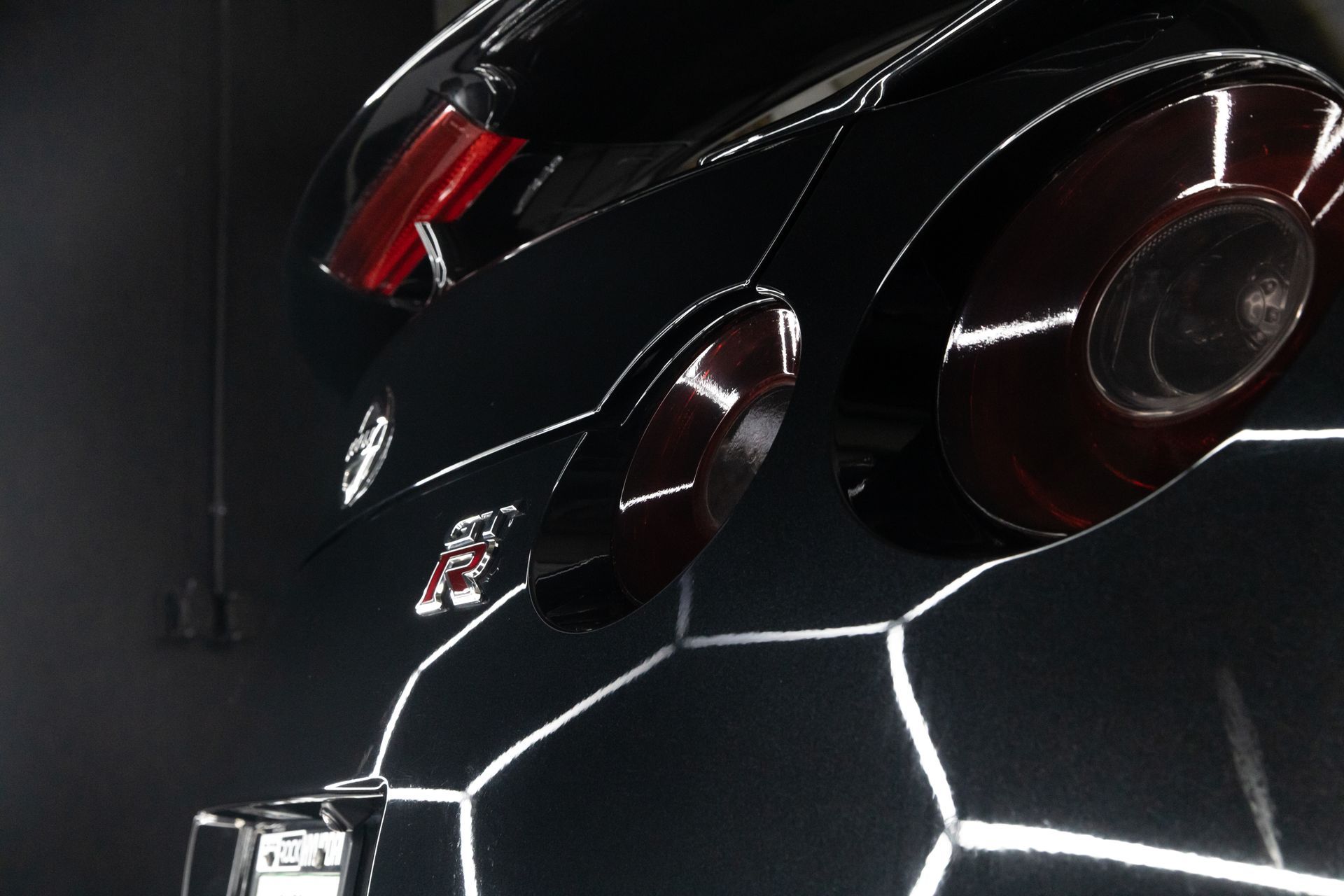 Black sports car rear details, illuminated panels.