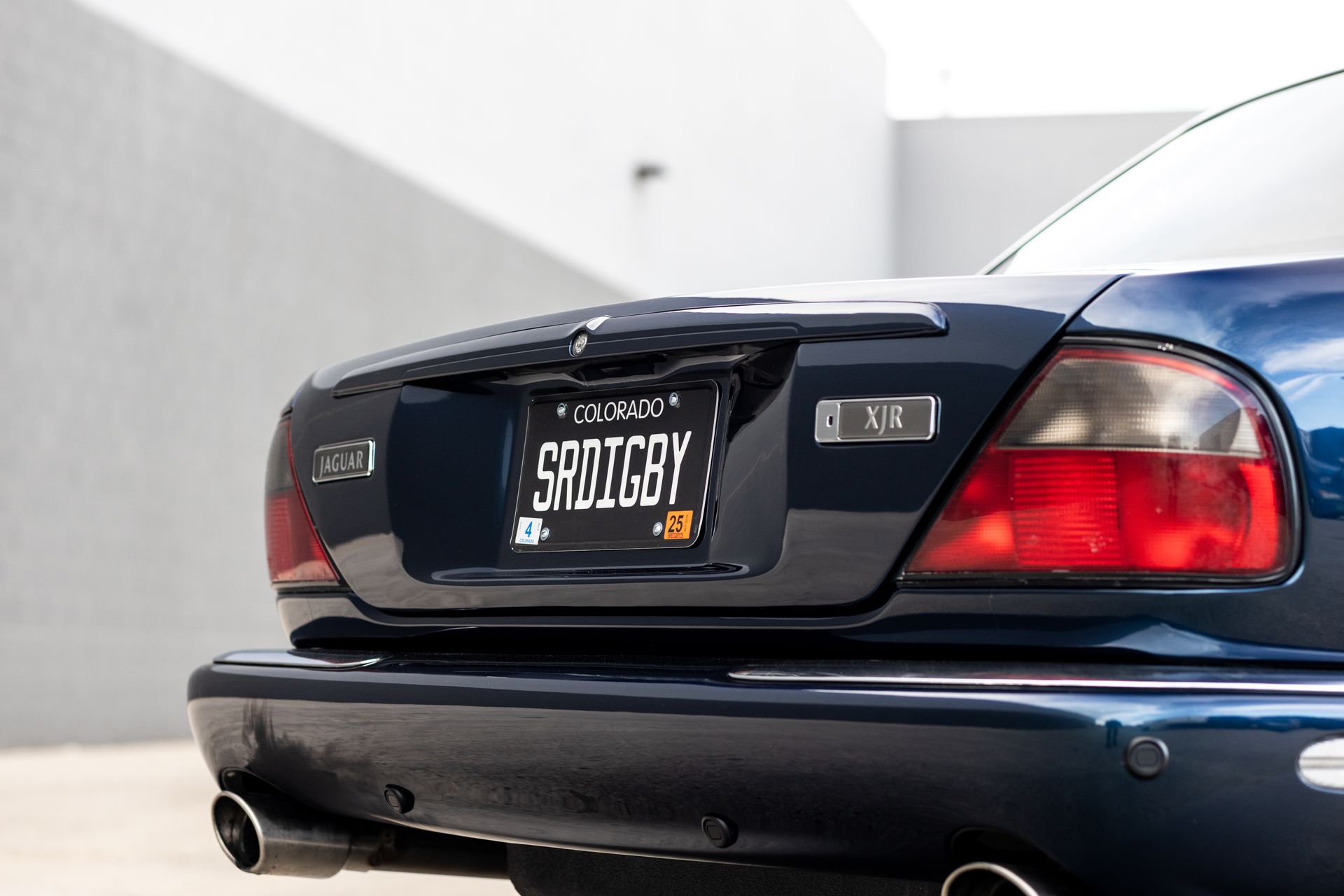 Dark blue Jaguar rear, with license plate 