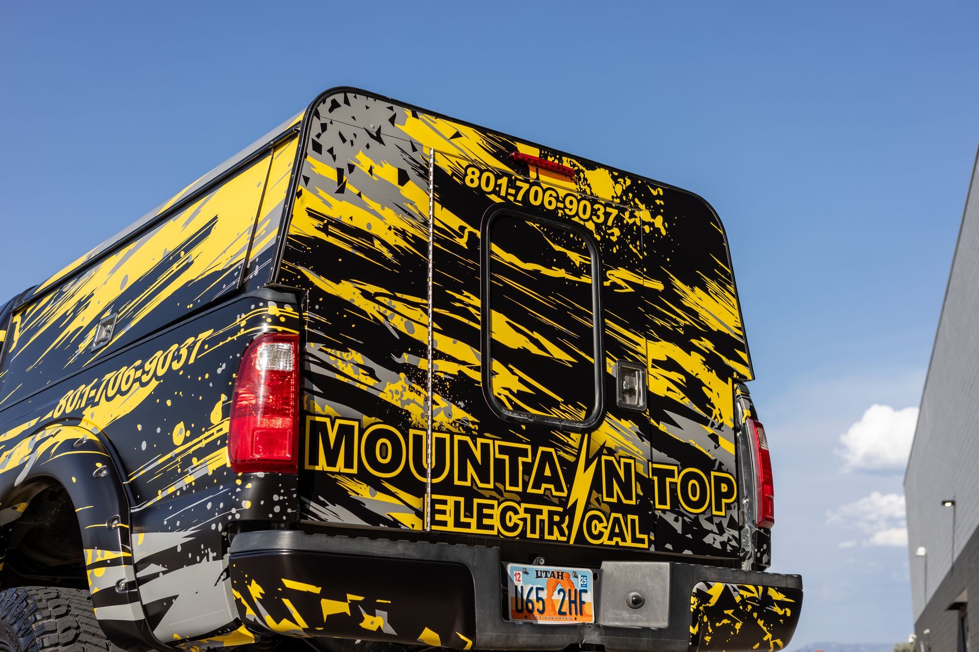 Black truck with yellow splatter paint; 