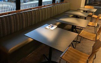 A row of tables and chairs in a restaurant.