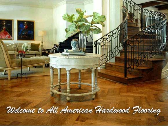 Elegant foyer with hardwood floors, spiral staircase, and table.