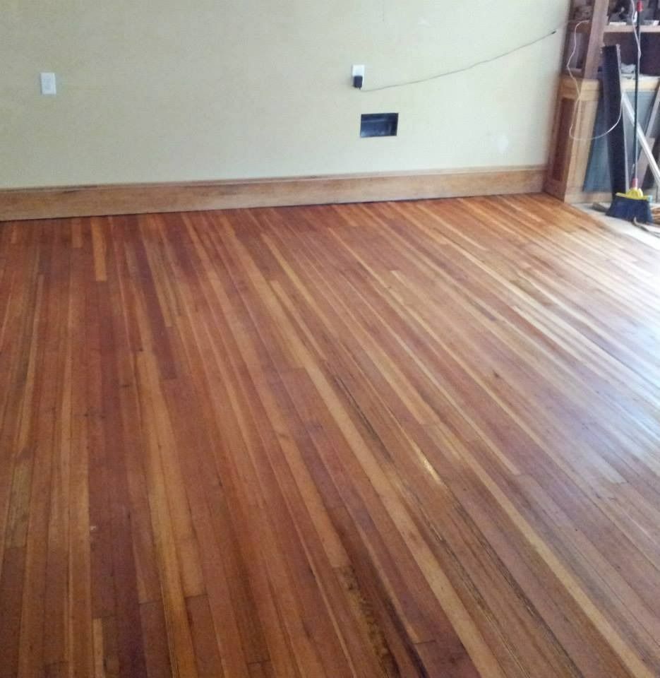 Wood floor with glossy finish and tan walls.