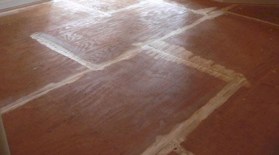 Red-brown tiled floor with white grout lines; angled perspective.