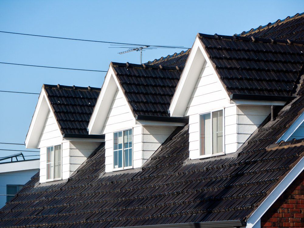 Attic Windows on the Black Tile Roof of Residential House — Second-Hand Roof Tiles in Maitland, NSW