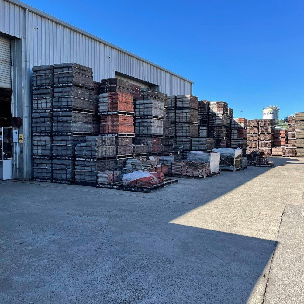 Warehouse with Plenty of Different Recycled Roof Tiles in Front