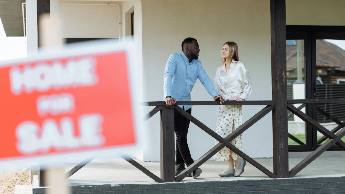 A happy homeowner looking at a financial plan for their Northwest Ohio home.