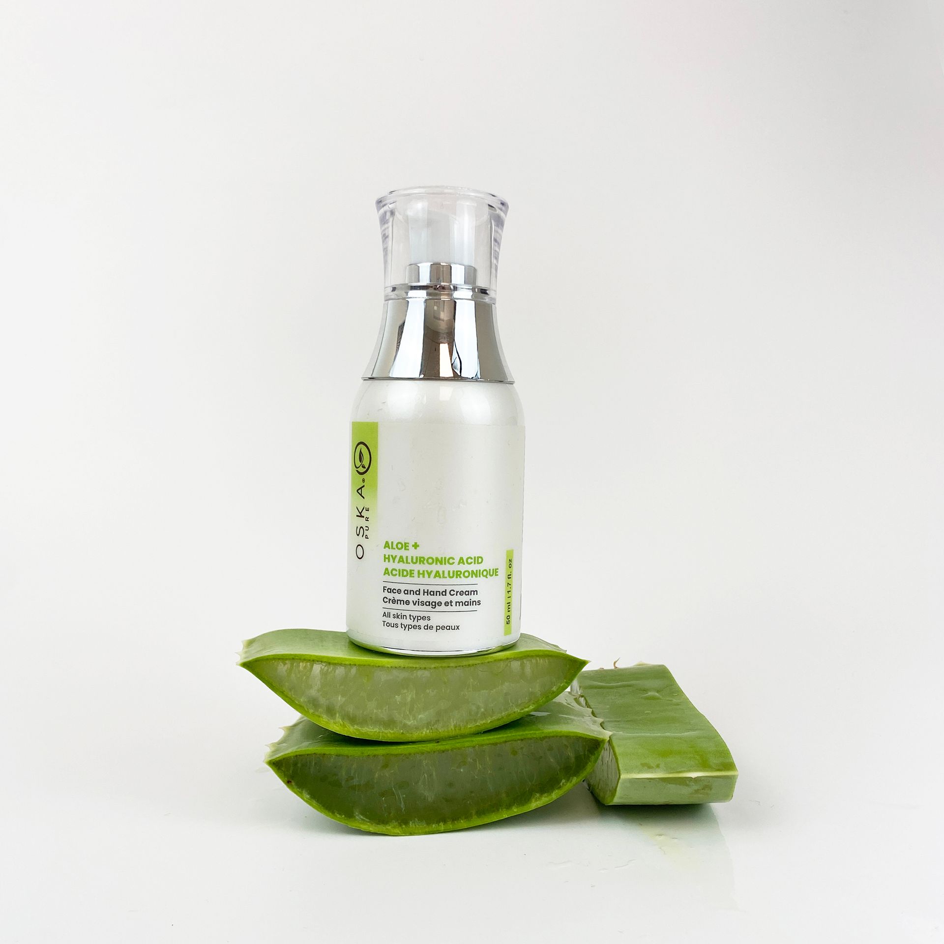 Aloe vera product bottle with aloe vera leaves on a white background.