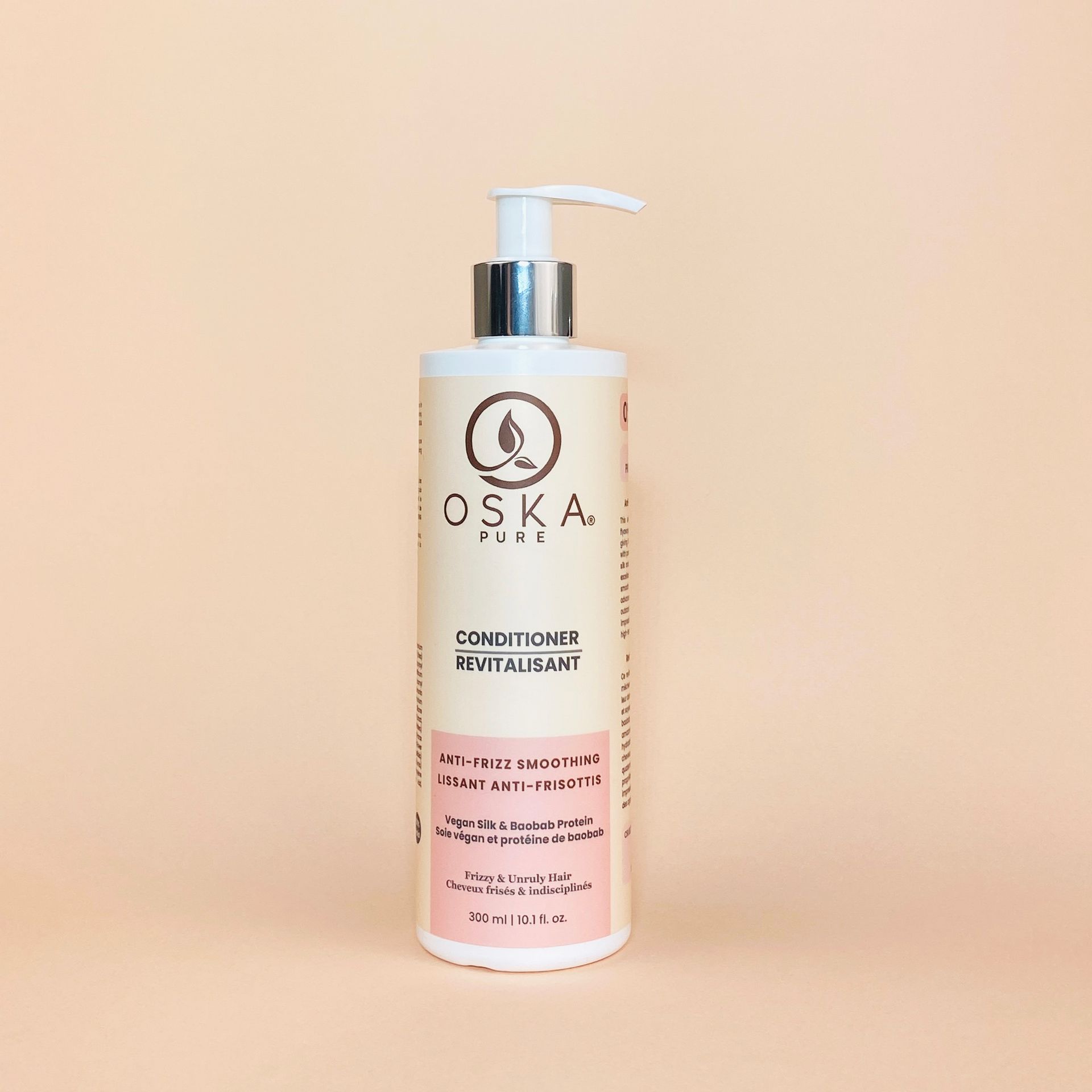 A bottle of OSKA PURE conditioner on a peach background.