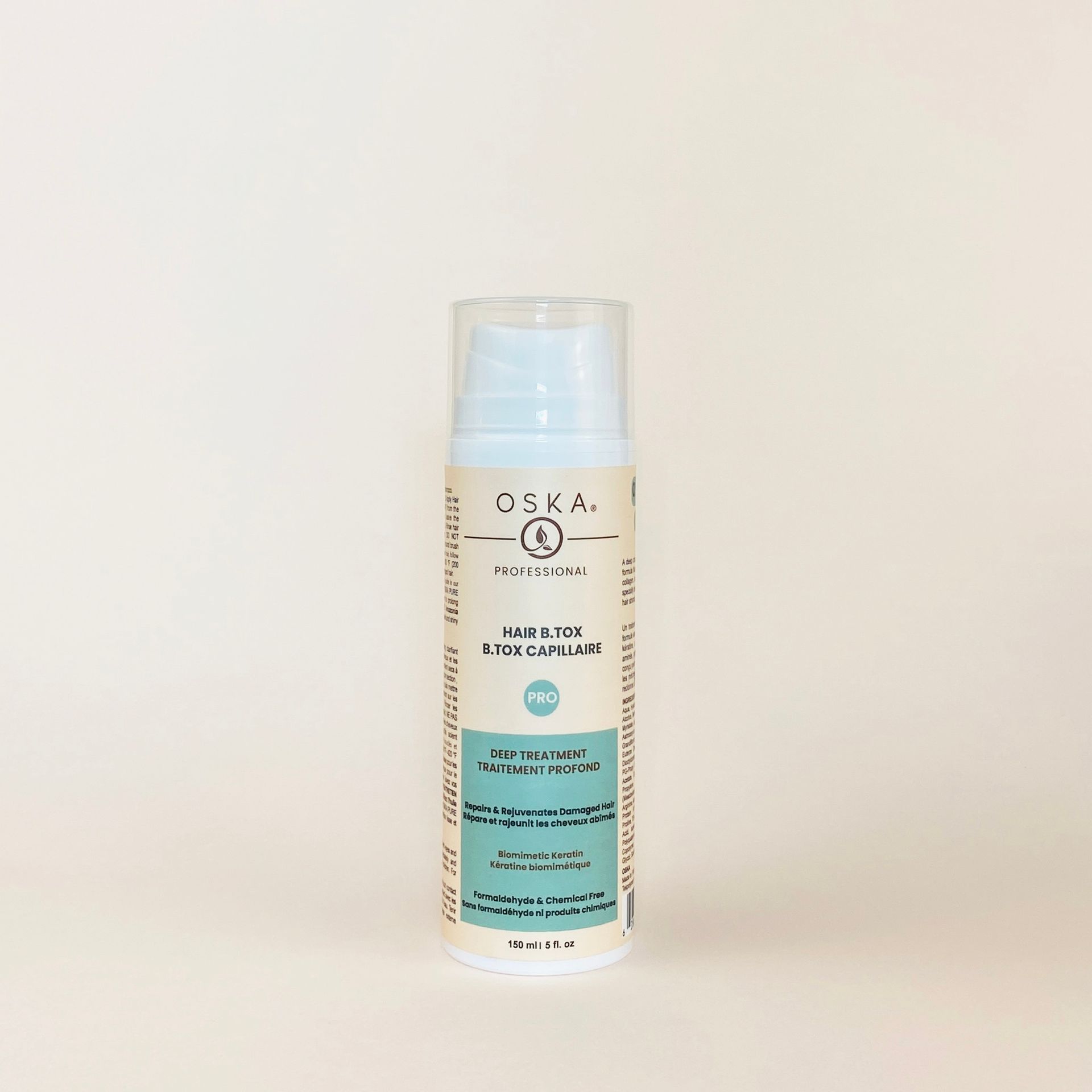 Bottle of OSKA face serum with blue and white label, standing on a light surface.