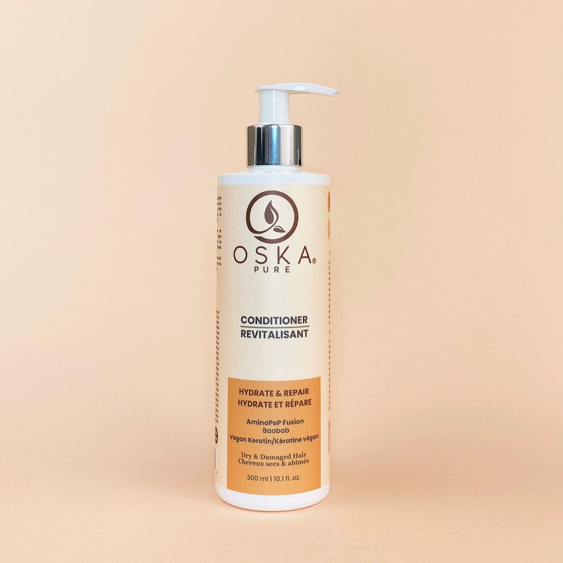 Bottle of OSKA Pure conditioner with a pump on a beige background.