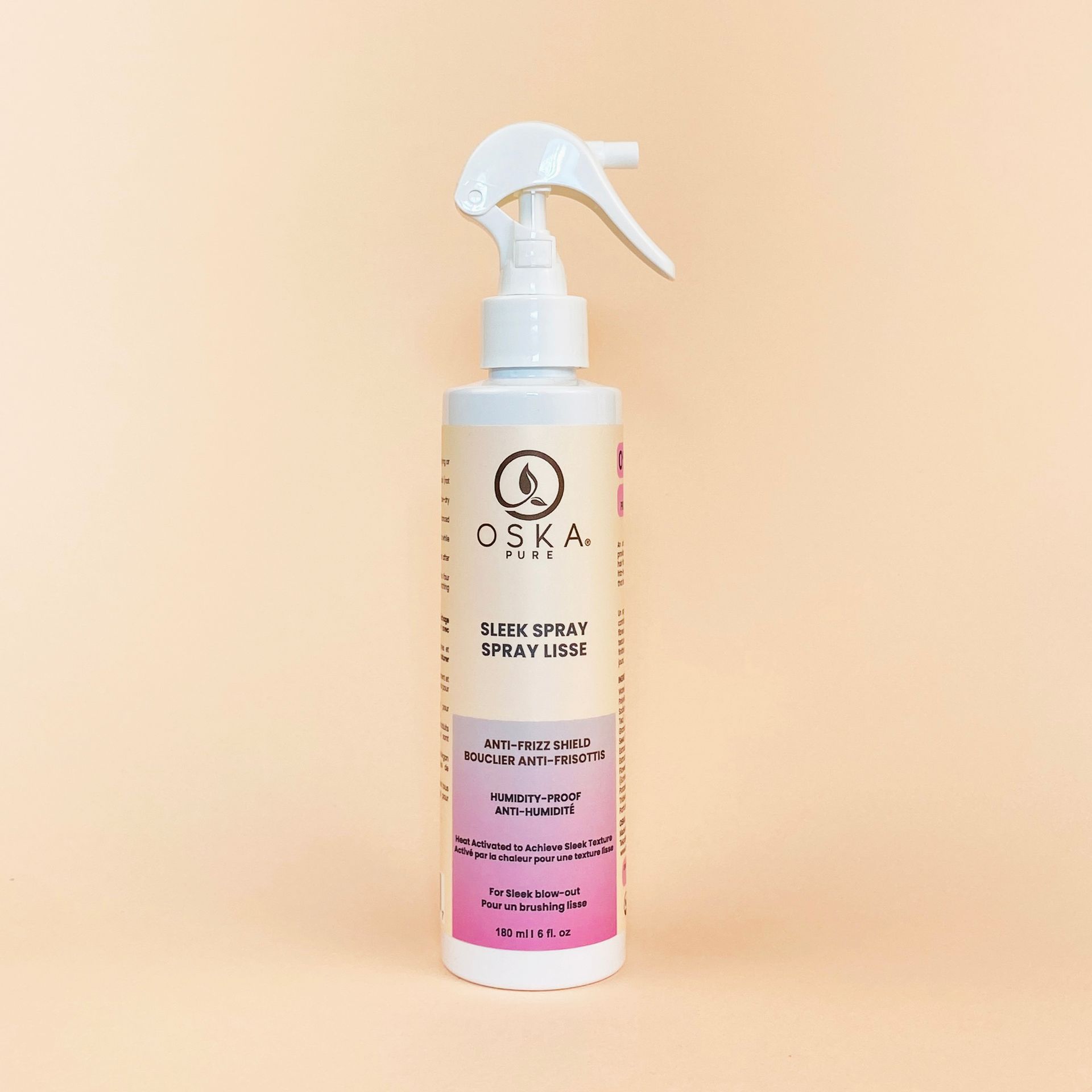 White spray bottle of CSKA hair product, pink and beige label.