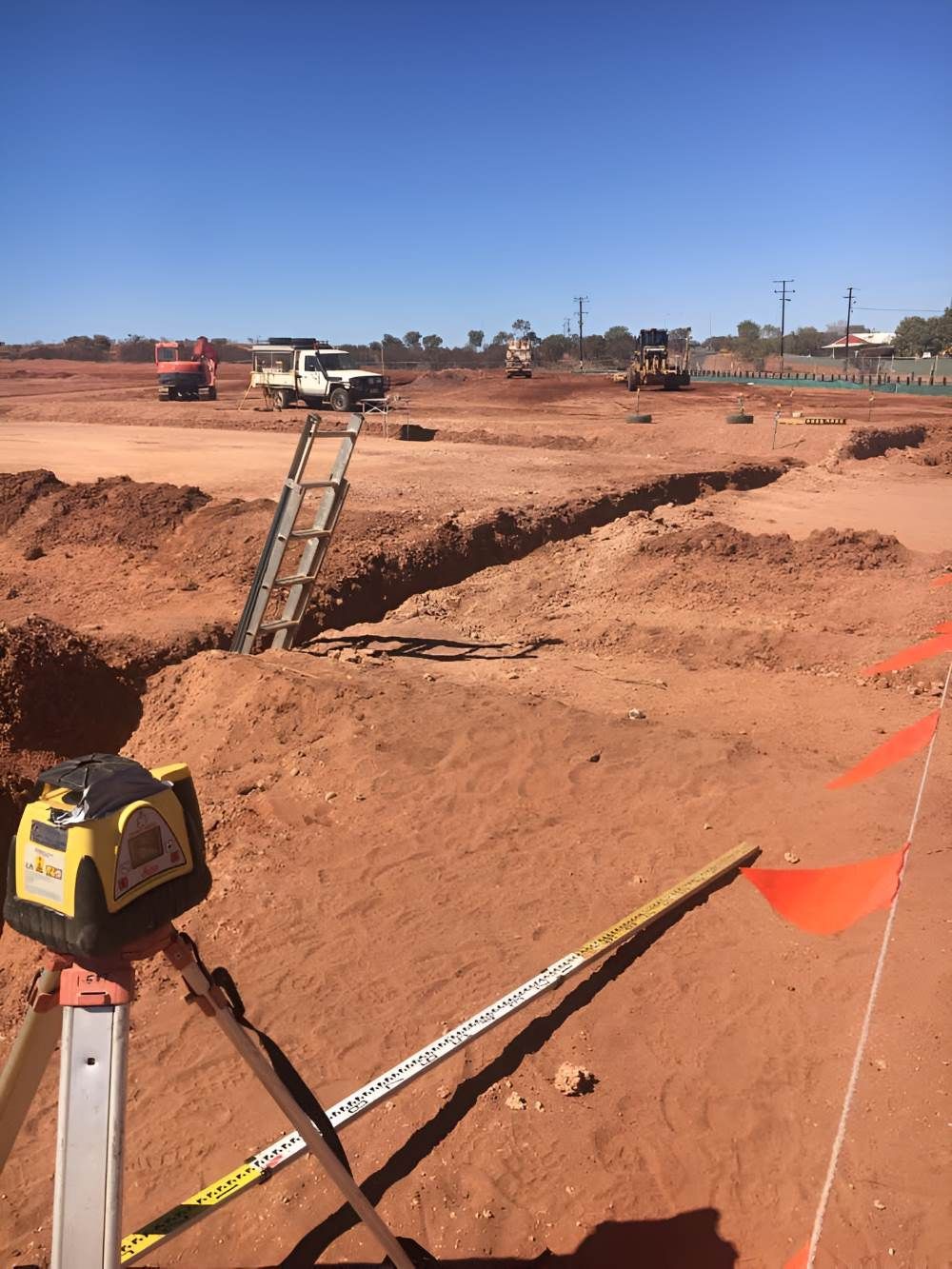 A Person Is Using a Laser Level on A Construction Site — ASPLUM & CIVIL In Alice Springs, NT