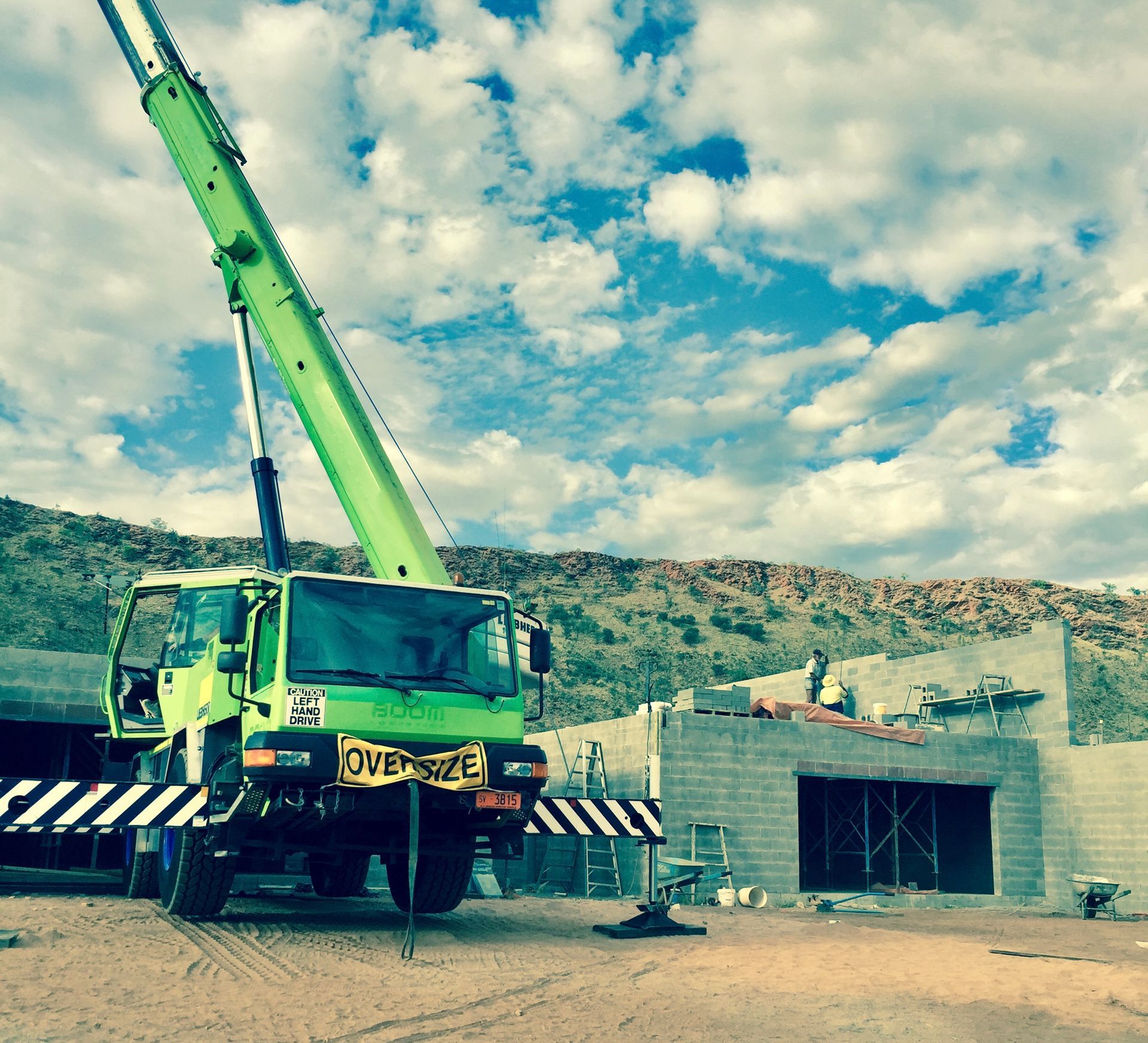 A green truck with a license plate that says oversize — ASPLUM & CIVIL In Alice Springs, NT