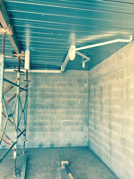 An Empty Room With a Metal Ceiling and Brick Walls — ASPLUM & CIVIL In Alice Springs, NT