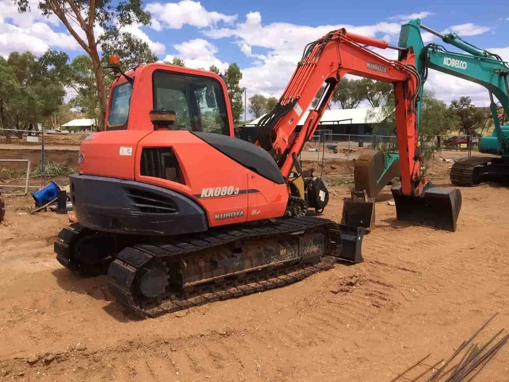 A Red and Black Excavator is Parked in the Dirt Next to a Green Excavator — ASPLUM & CIVIL In Alice Springs, NT