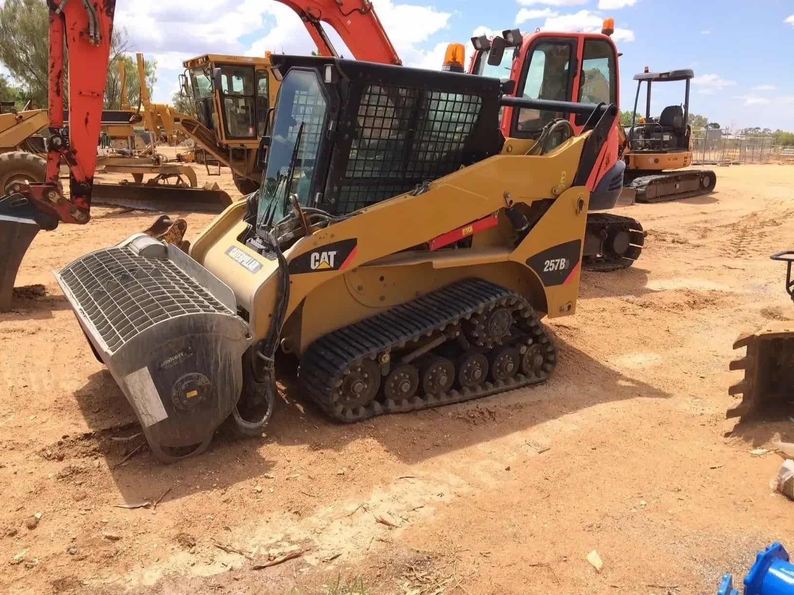 A Cat Skid Steer is Parked in a Dirt Lot — ASPLUM & CIVIL In Alice Springs, NT