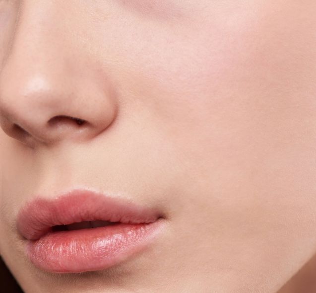 A close up of a woman 's face with her mouth open.