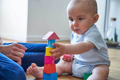 Baby Playing With Coloured Wooden Blocks — Burtonsville, MD — Childway Early Learning Center