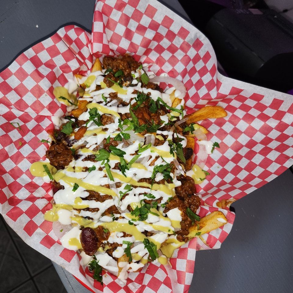 A close up of a tray of food on checkered paper