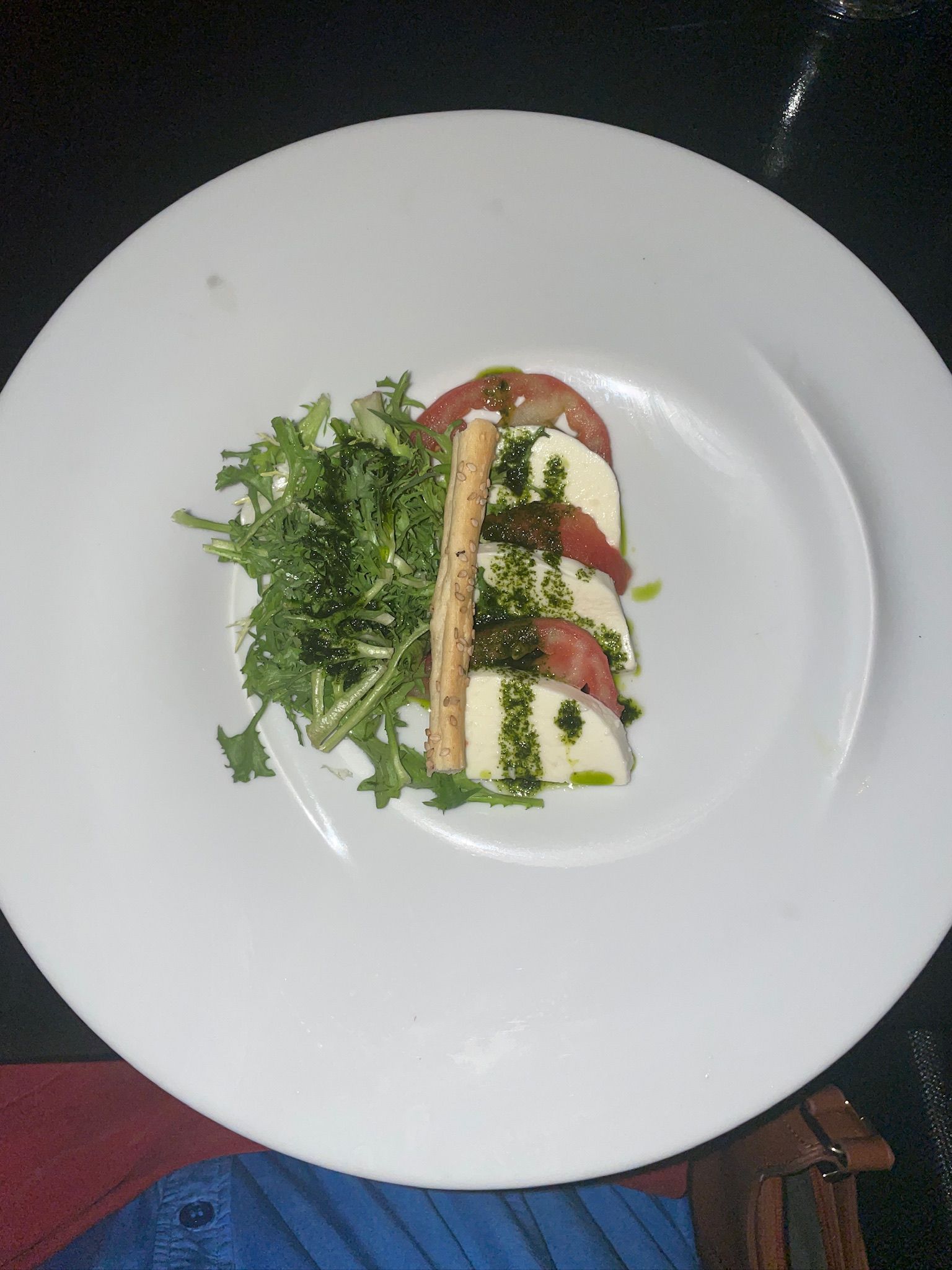 A white plate topped with a salad and cheese