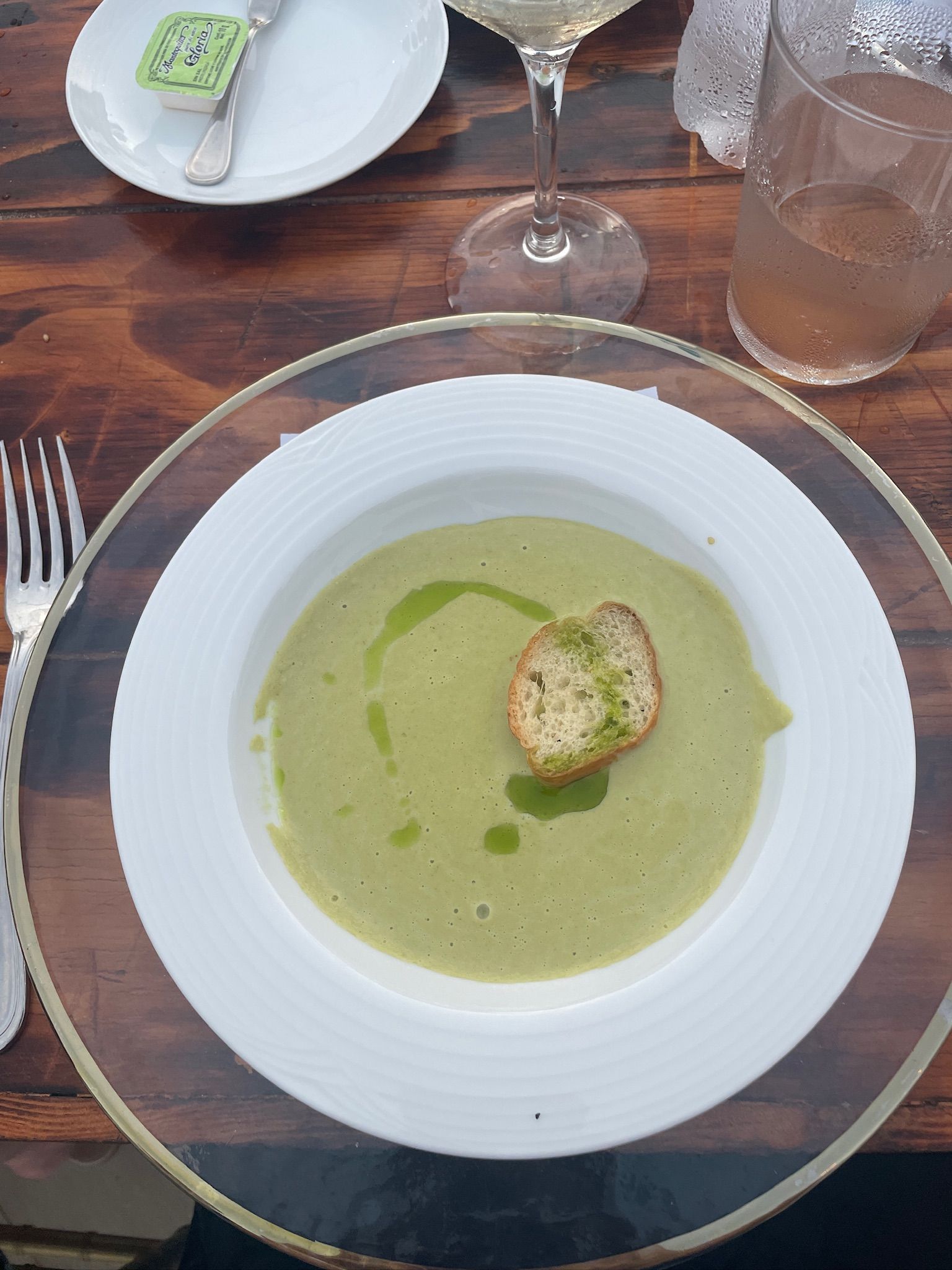 A bowl of soup with a piece of croutons on top