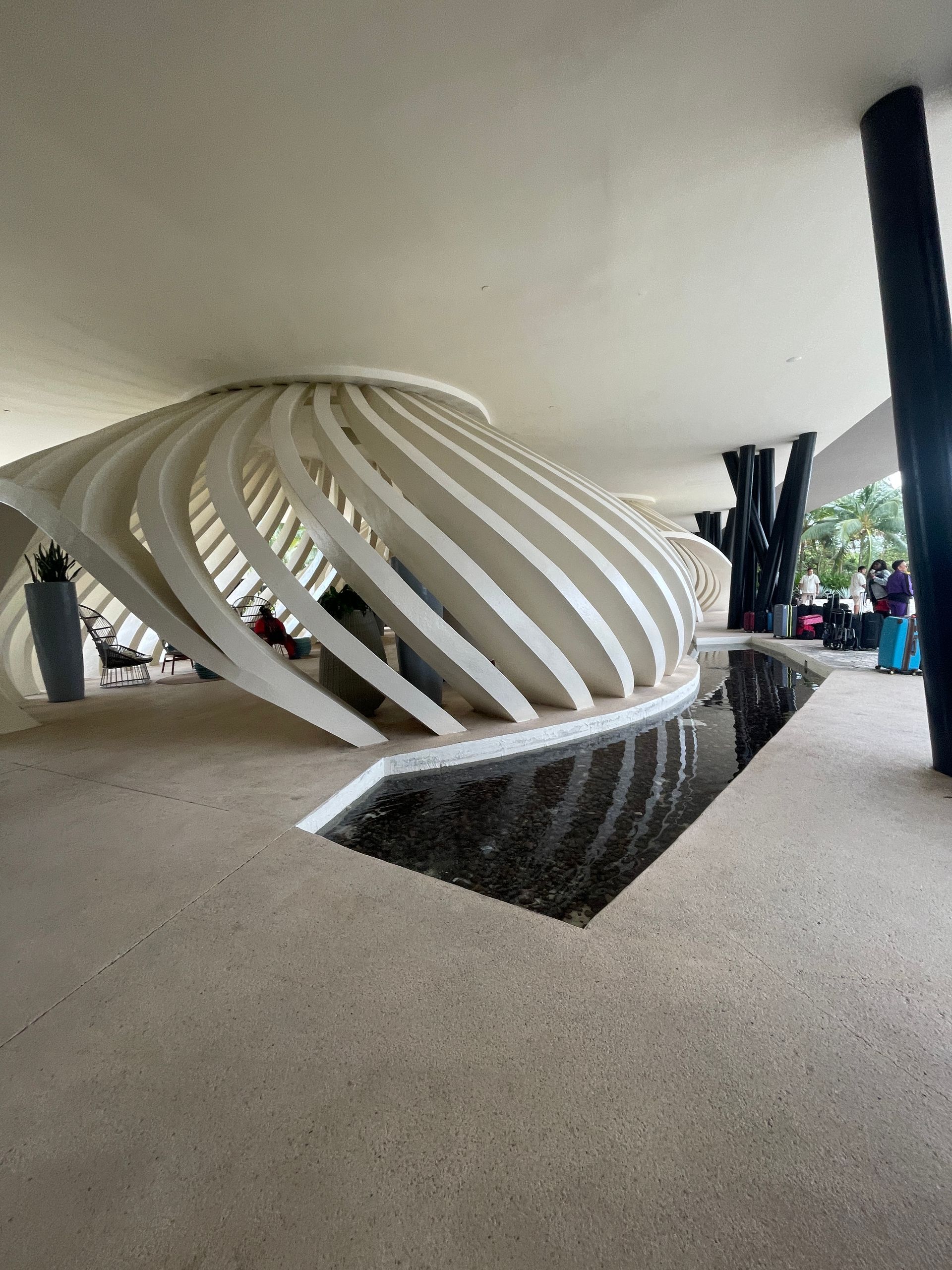 A woman in a green dress is standing in front of a vacation mood sign.