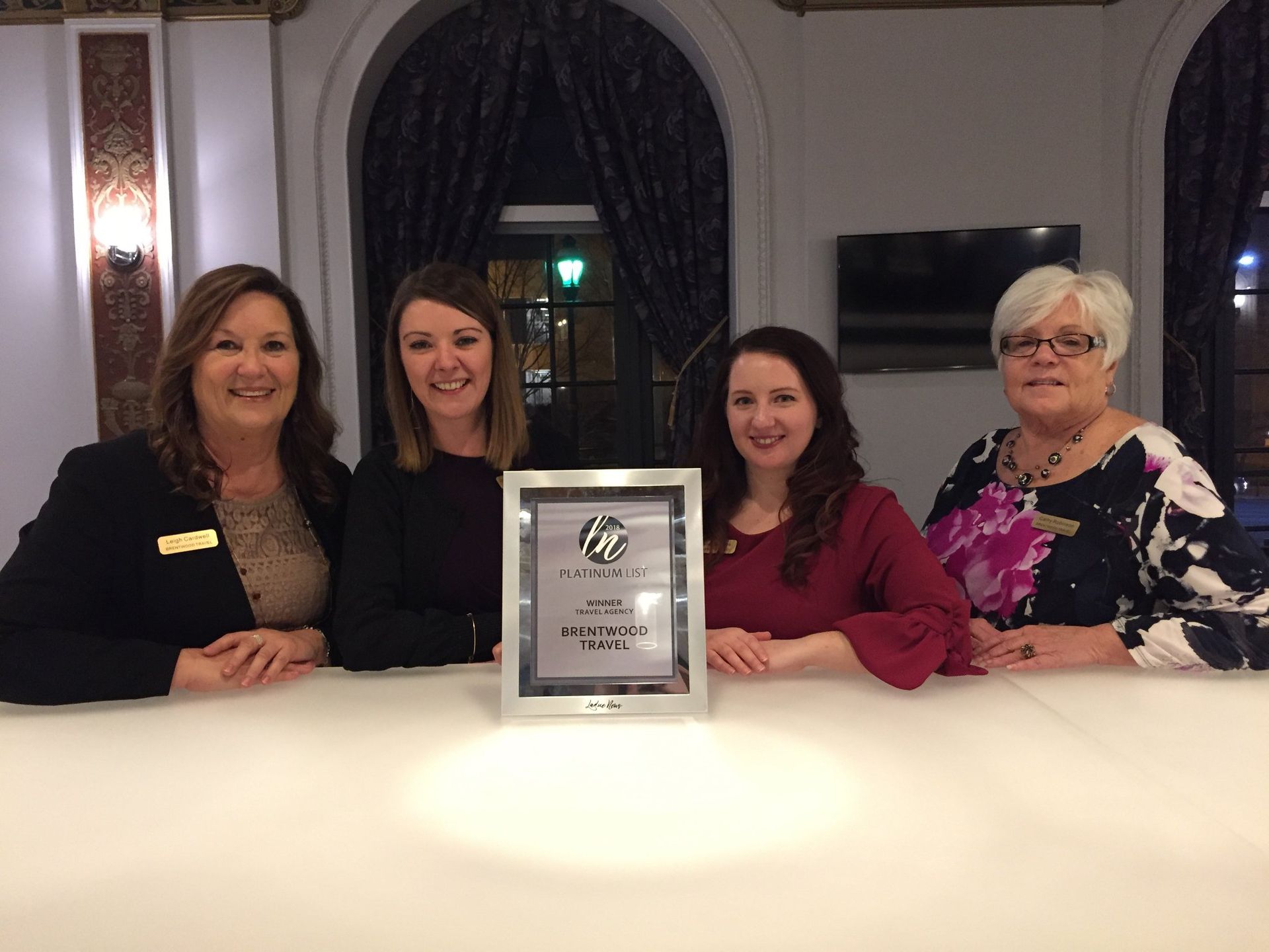group of women holding an award A group of women standing next to each other holding a certificate.