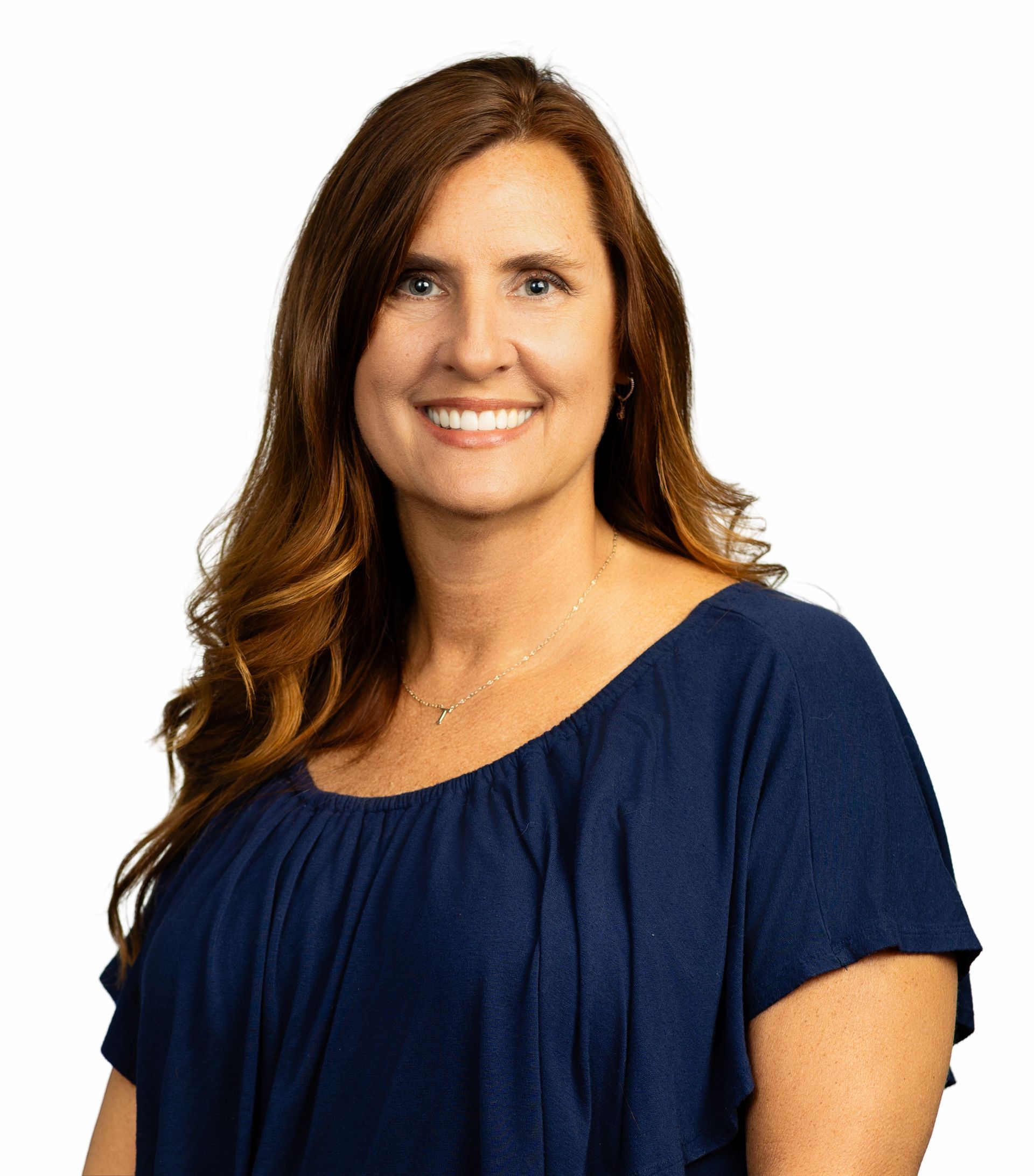 A woman with red hair and blue eyes is smiling for the camera.
