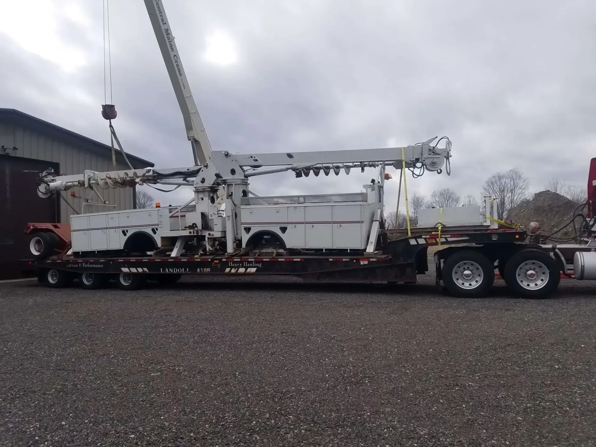 A large crane is sitting on top of a semi truck.