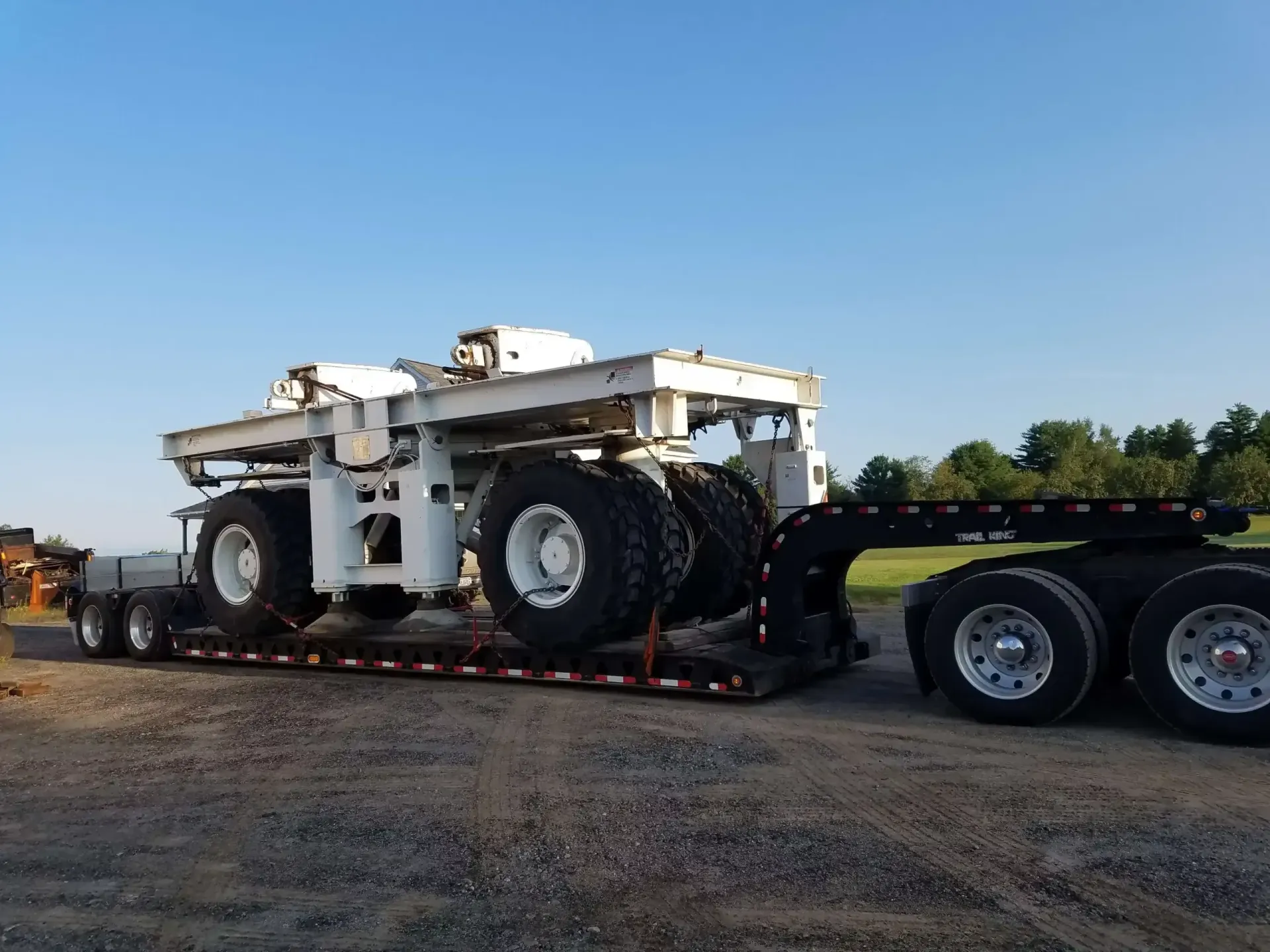 A semi truck with a crane on the back of it