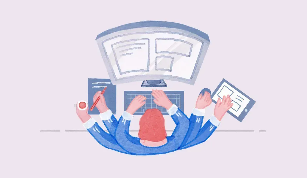 A man is sitting at a desk using a computer and a tablet.