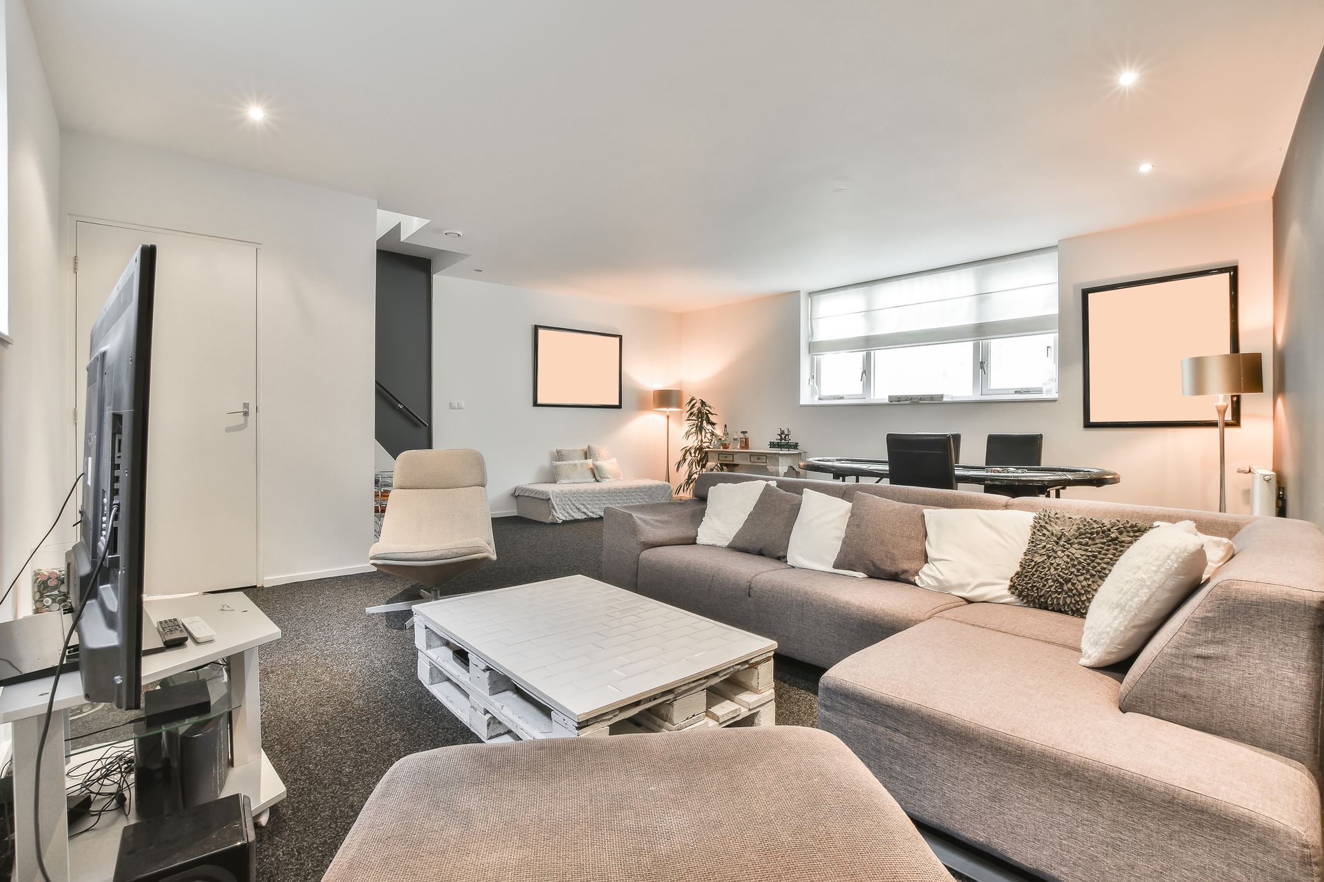 Spacious living room with large sectional sofa, coffee table, TV, and modern decor.