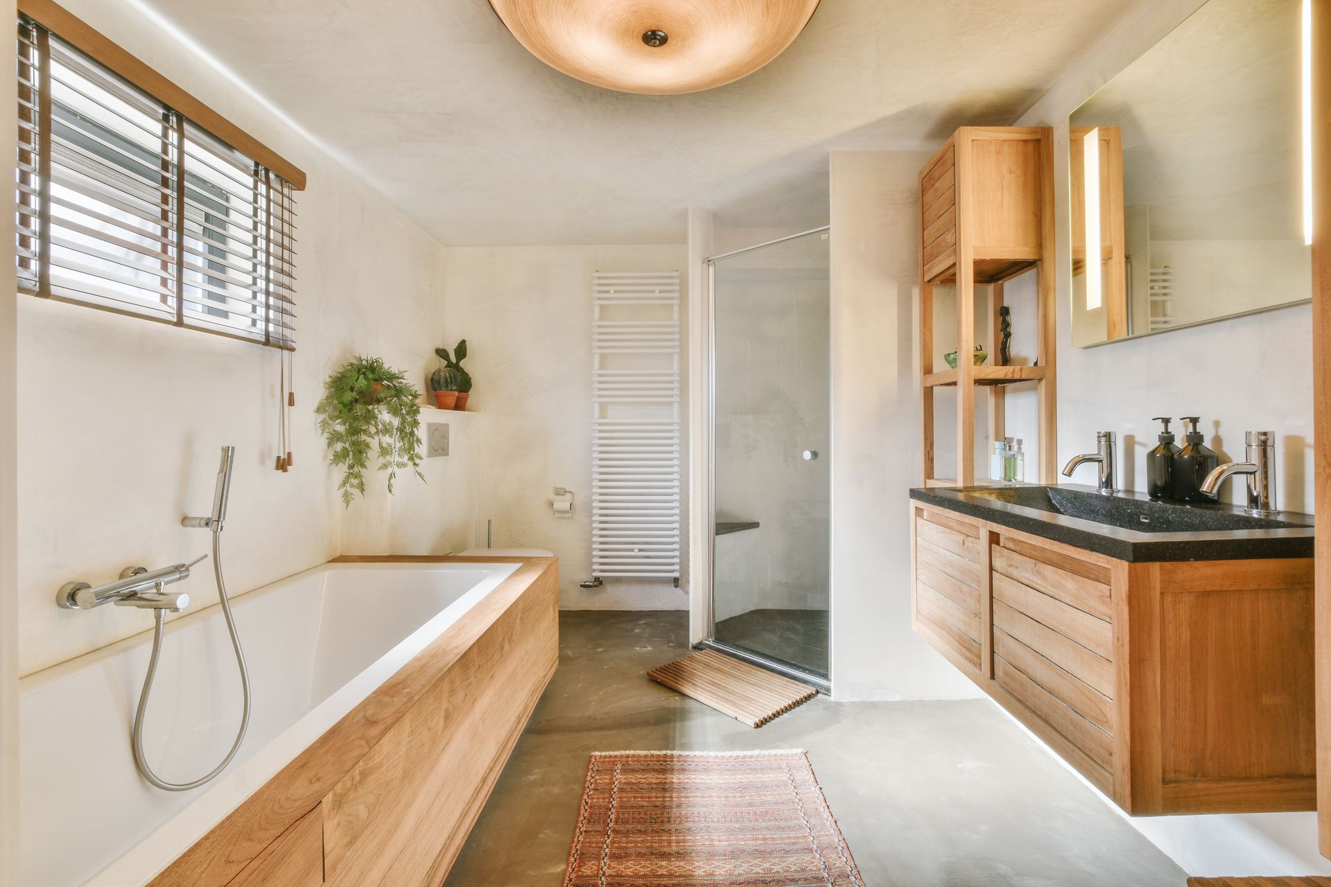 Bathroom with wooden accents, soaking tub, shower, and double vanity.