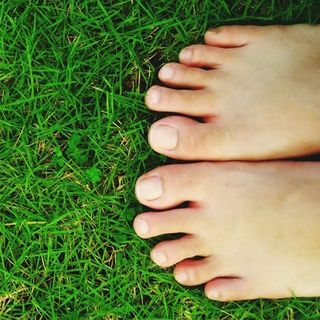 feet on green grass